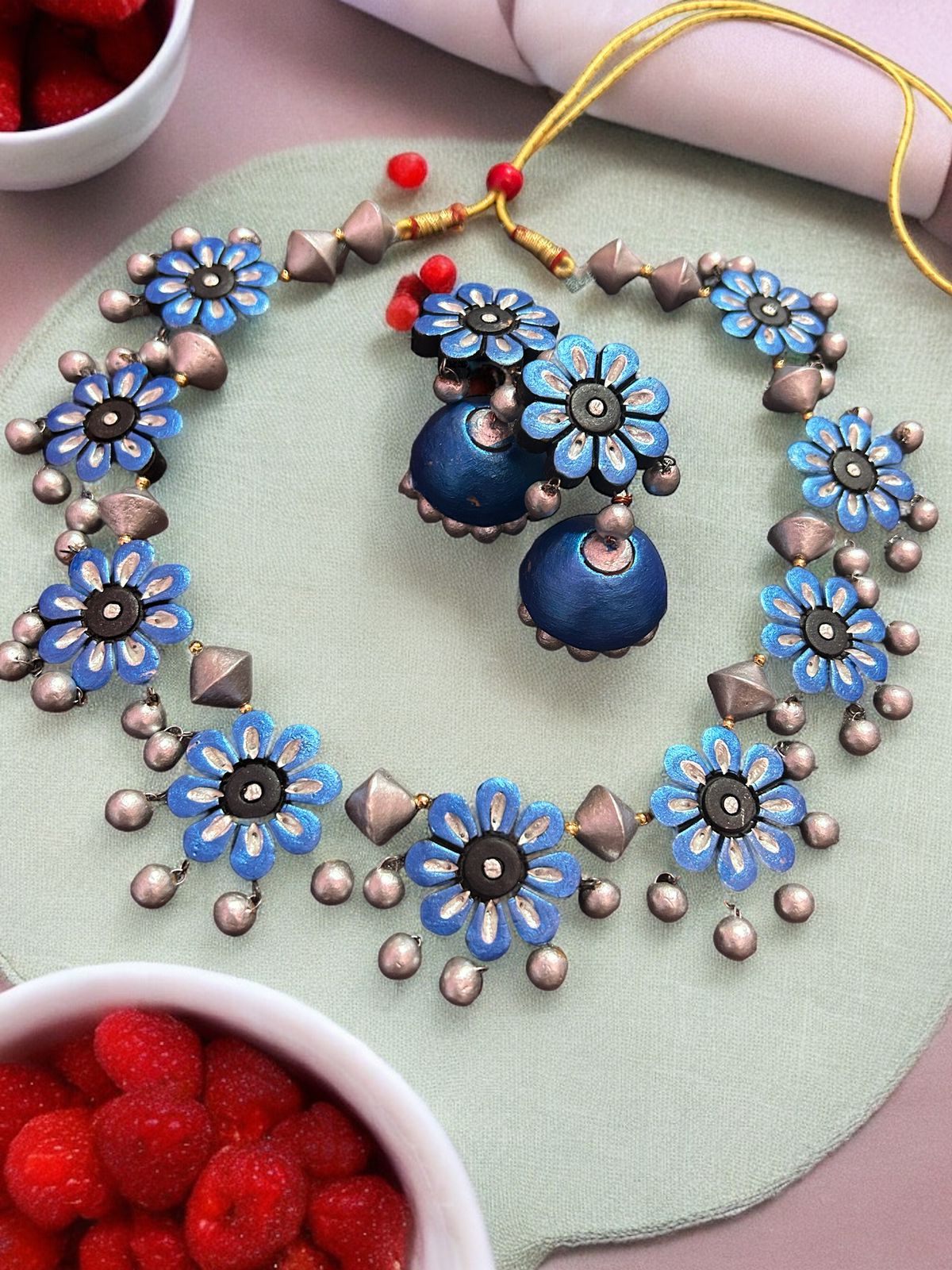 Strings of floral design in terracotta blue