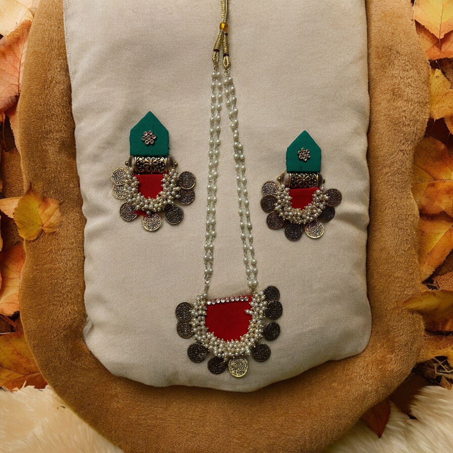 Ethinic jewelry set on fabric with accessories red and green