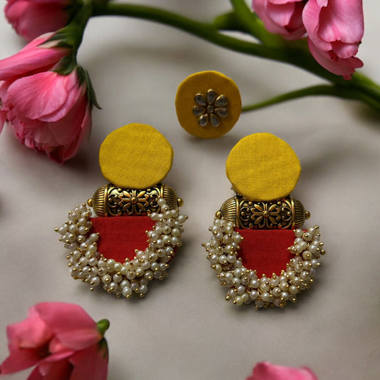 Ethinic earring and ring set on fabric with accessories red and yellow