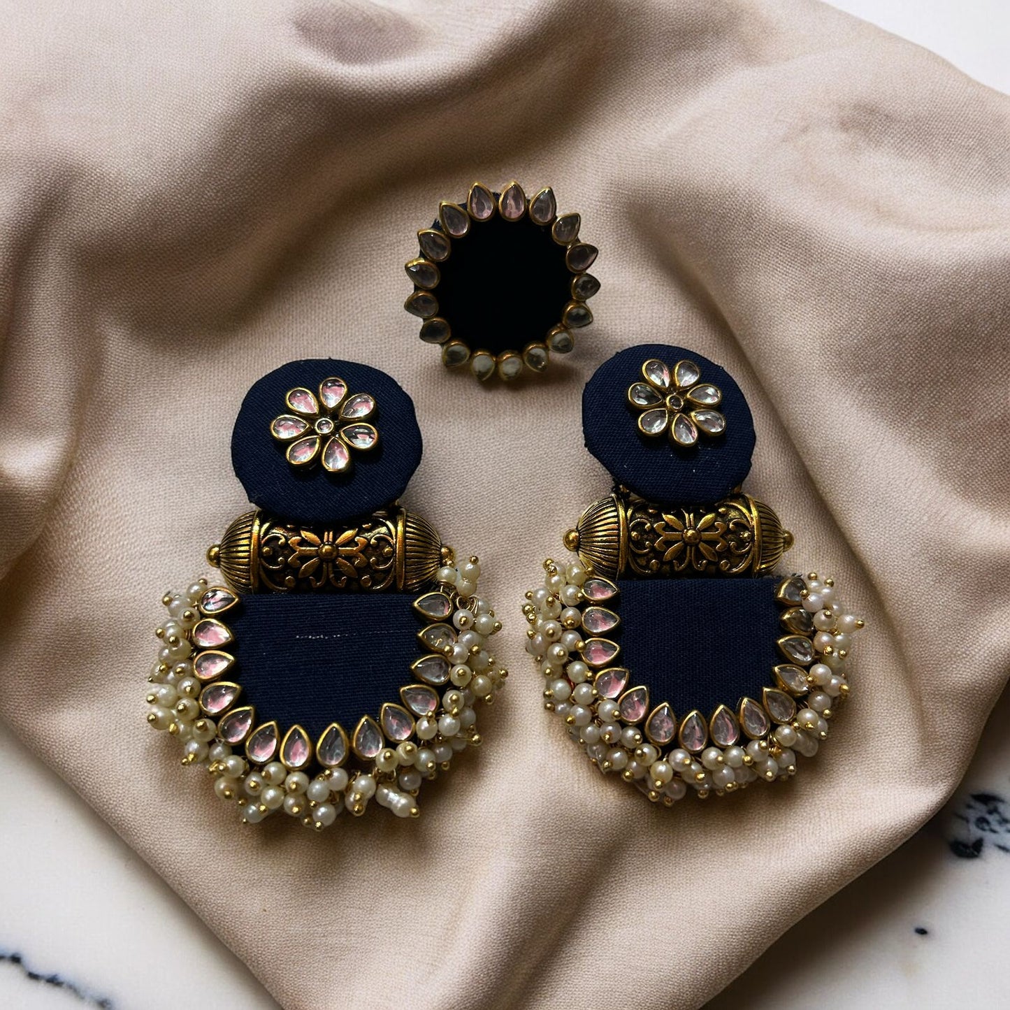 Ethinic earring and ring set on fabric with accessories blue